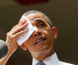 President Obama wipes his brow while he speaks about his vision to reduce carbon pollution in Washington