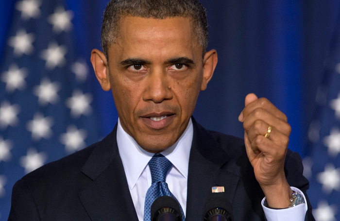 President Barack Obama continues to speaks about national security, Thursday, May 23, 2013, at the National Defense University at Fort McNair in Washington, as CODEPINK founder Medea Benjamin of Code Pink shouted at him from the back of the auditorium.  (AP Photo/Carolyn Kaster)