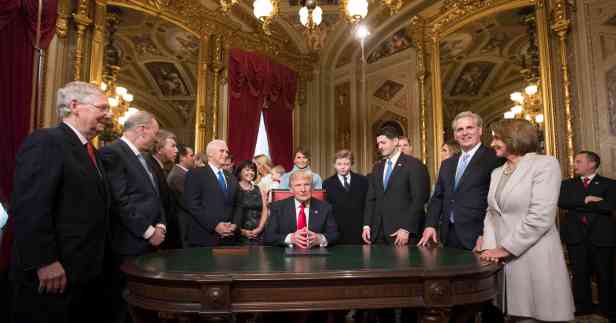President Donald Trump is joined by the Congressional leadership and his family as he formally signs his cabinet nominations into law, in the President's Room of the Senate, at the Capitol in Washington, Friday, Jan. 20, 2017. (AP Photo/Scott Applewhite, Pool)